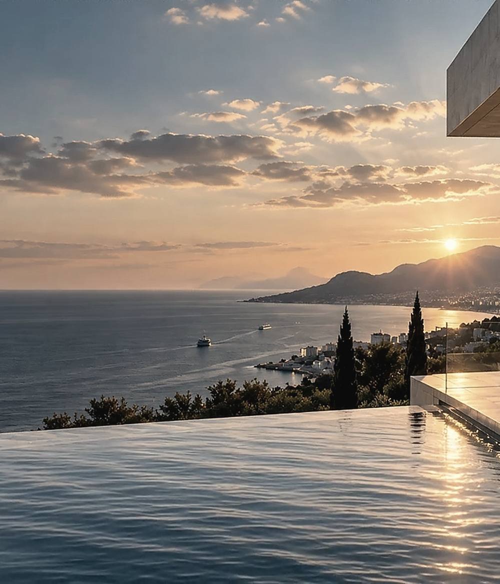 Sea and coastline at sunset seen from a hillside property
